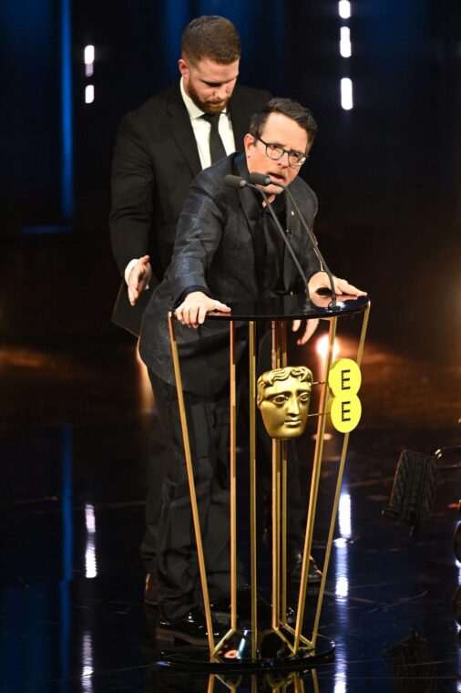 Michael J Fox presents the Best Film Award on stage during the EE BAFTA Film Awards at The Royal Festival Hall in London, England, on February 18, 2024. | Source: Getty Images