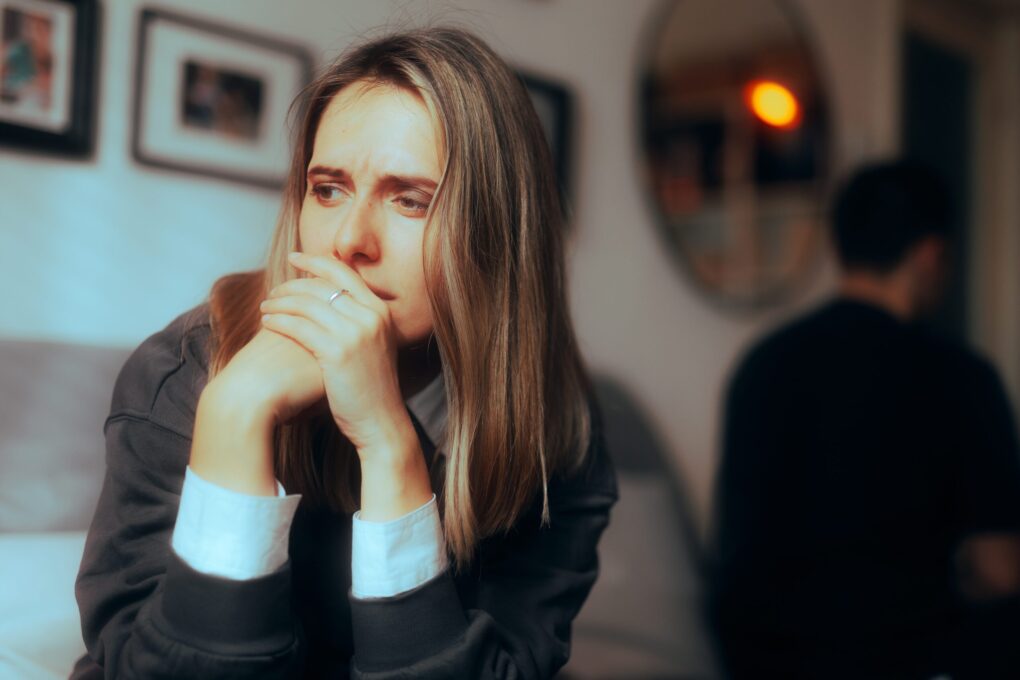 Unhappy couple sitting apart after an argument | Source: Shutterstock