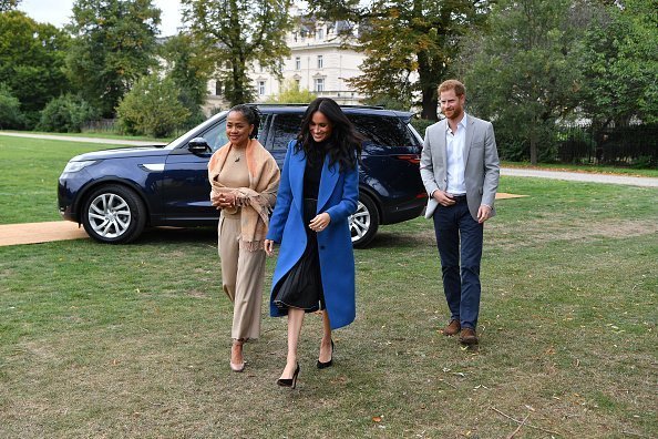 Meghan Markle, Doria Ragland, and Prince Harry during the launch of a cookbook with recipes from a group of women affected by the Grenfell Tower fire | Source: Getty Images