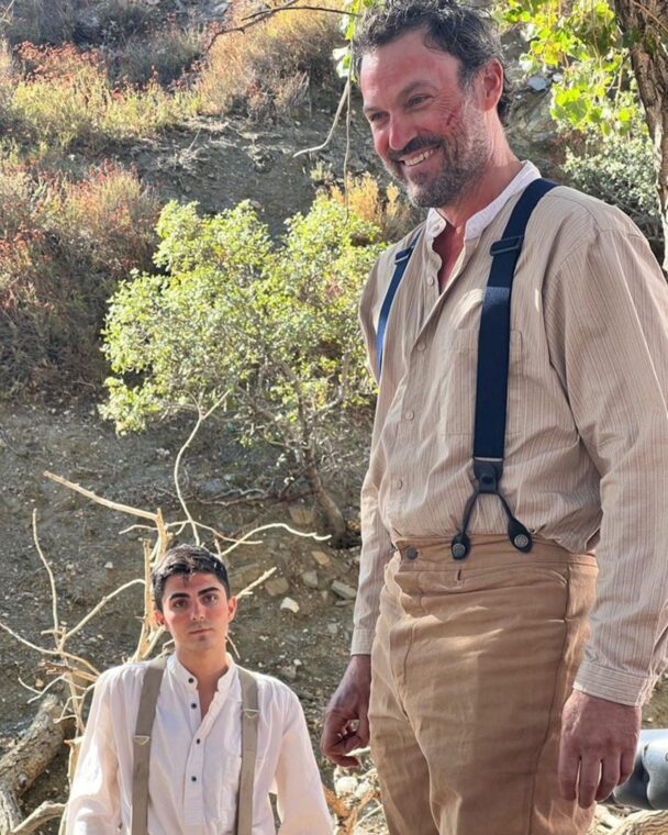Brian Austin Green and another man in period clothing on a hillside.
